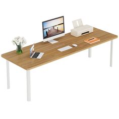 a computer monitor sitting on top of a wooden desk next to a keyboard and mouse