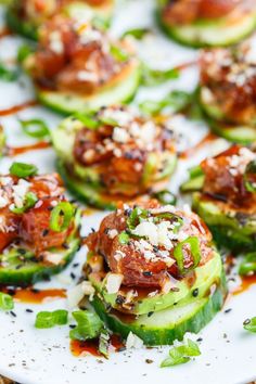 small cucumbers with toppings on a white plate