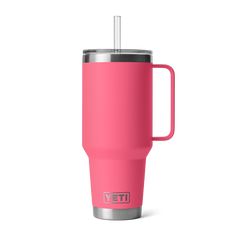 a pink yeti travel mug with a straw in it