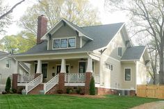 a white house with two story and front porch