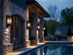 an outdoor swimming pool with lights on the side