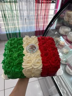 a cake made to look like the flag of italy in front of a bakery display case