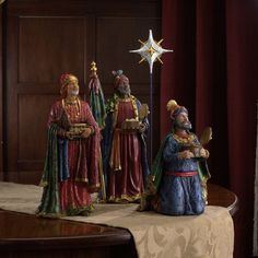 three figurines are standing next to each other in front of a christmas star