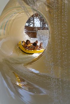 people are riding on a tube in the water at an amusement park or water park