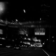 black and white photograph of city street at night