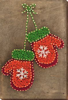 two red mittens with snowflakes on them are made out of string and beads