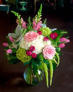 a vase filled with pink and white flowers