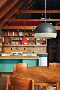 a kitchen with an island and wooden chairs next to the counter top in front of it