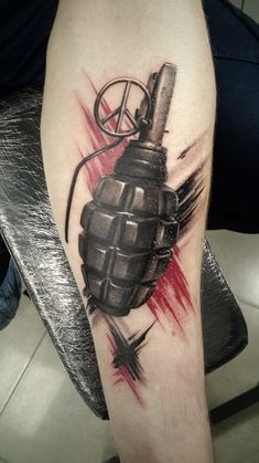 a tattoo on the arm of a man with a hockey glove and peace sign in it