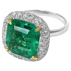 This exquisite emerald and diamond ring features a bright green octagonal shaped emerald at the center, surrounded by a glittering halo of diamonds. Crafted in 18k white and yellow gold The center stone is a 5.73ct octagonal emerald with very well saturated vivid green color. Emerald And Diamond Ring, Emerald Diamond Ring, Modern Engagement Rings, Gold Cocktail Ring, Jewels Rings, Colombian Emeralds, 18k Gold Ring, 18k Yellow Gold Ring, Modern Ring