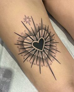 a woman's thigh with a heart and fireworks tattoo on the side of her leg