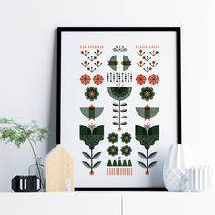 an art print with flowers and plants on the wall next to a white shelf in a room