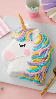 a cake decorated like a unicorn on top of a table