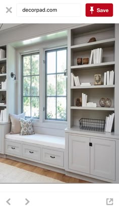 a window seat with built in bookshelves next to a window filled with books