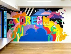 a large mural on the side of a wall in an office building that says dream