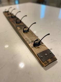 a wooden rack with glasses on it sitting on top of a white countertopstop