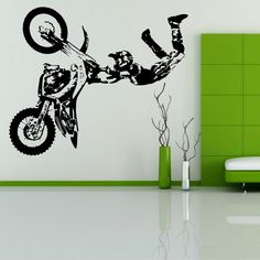 a wall decal with a dirt bike rider doing a trick on it's side