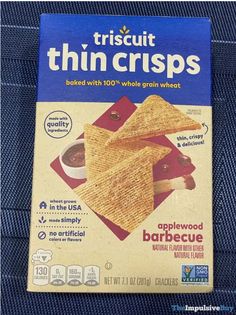 a box of thin crispes sitting on top of a blue piece of cloth,