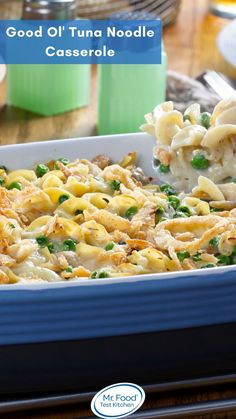 a casserole dish with pasta and broccoli in it on a table