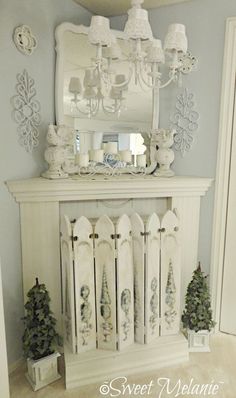 a white fireplace mantle with christmas decorations on it