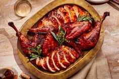 a platter filled with sliced chicken and garnished with herbs