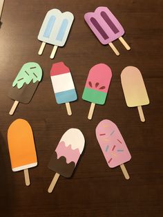 six popsicles with ice cream and sprinkles on them sitting on a table