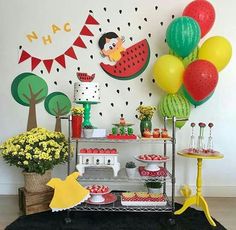 a birthday party with balloons, cake and decorations