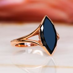 Univers's Eye- an Art Deco-inspired engagement ring that captures the mysterious allure of the cosmos. Set in luxurious rose gold, this stunning piece features a 2.22-carat marquise-cut black diamond, enhanced to reveal its deep, captivating beauty. Adorned with 0.9 carats of round accent diamonds, the Univers's Eye boasts a total carat weight of 2.31, combining vintage elegance with modern sophistication. This ring is a perfect choice for those who seek a distinctive symbol of love, blending ti Black Ruby Ring, Black Onyx Ring Engagement, Black Gold Ring Women, Marquise Engagement Ring, Black Diamond Necklace, Black Diamond Engagement Ring, Black Diamond Studs, White Diamond Earrings, Onyx Engagement Ring