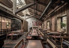 the interior of a restaurant with wooden tables and chairs