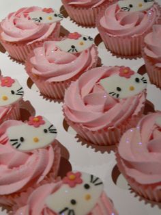 hello kitty cupcakes with pink frosting and white icing are arranged on a table