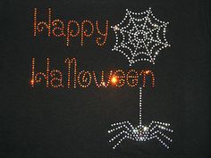 a black t - shirt with the words happy halloween written in orange and white lights