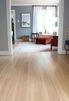 a living room with hard wood floors and blue walls