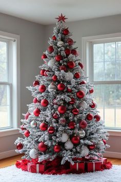 a white christmas tree with red and silver ornaments