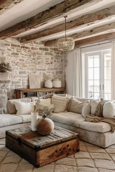 a living room filled with furniture and stone walls