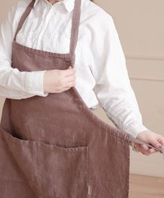 a woman wearing an apron and white shirt