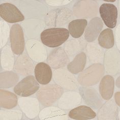 a stone wall with several different colored rocks on it's sides and one is white, brown, and beige