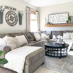 a living room filled with lots of furniture and decor on top of a white rug