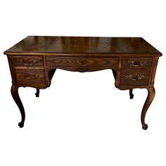 an antique desk with drawers and legs