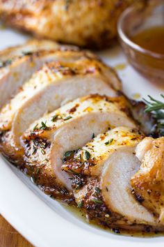 chicken with herbs and sauce on a white plate