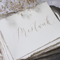 a piece of paper with the word prettick written on it next to a spoon