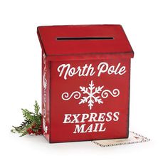 a red mailbox with the words north pole express mail on it and a christmas decoration