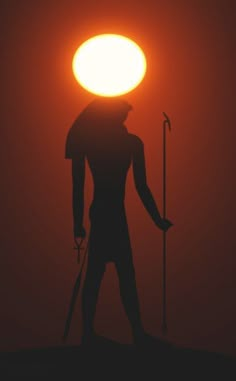 the silhouette of a man holding a staff and standing in front of an orange sun