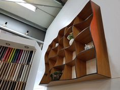 a wooden shelf with many different colored pencils on it