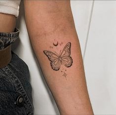 a woman's arm with a butterfly tattoo on the left side of her arm