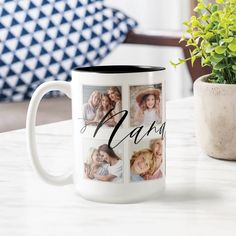 a coffee mug sitting on top of a table next to a potted plant