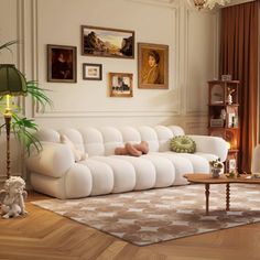 a living room filled with white furniture and pictures on the wall above it's windows