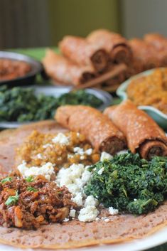 an assortment of food is displayed on a plate with other dishes in the back ground