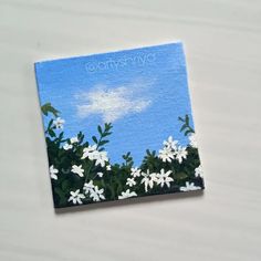 an acrylic painting of white flowers against a blue sky with the words, cherry blossom