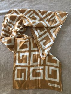 Gold and cream Givenchy logo "G" scarf from the early 1970's. In very good condition, no flaws. Measures approximately 66" x 15". The style is extremely versatile. Givenchy Logo, Long Silk Scarf, Vintage Givenchy, Monogram Logo, Shoe Box, Silk Scarf, Givenchy, Labour Day, Scarf Accessory