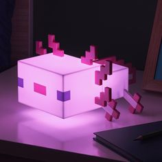 The 11cm (4.3") tall light is shaped like the pink blocky axolotl mobs from Minecraft. Turn it on to cast a warm light around your room. Power the icon light with 2x AAA batteries. The Axolotl Icon Light will make a great light-up addition to any gamer&apos;s living space. Make a great light-up addition to any gamer&apos;s living space. Bring the aquatic cave biome into your home with this Axolotl Icon Light. Dimensions: Size H10.7, W8.14, D7.6cm, Diameter 10.7cm.Length: 7.6cm. Bulb Informa Harry Potter Case, Sabre Laser, Minecraft Bedroom, Minecraft Room, To Buy, Night Light Kids, Band T Shirts, Star Wars Baby